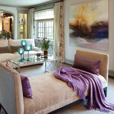 A couch with a purple blanket on it in a living room