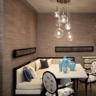 A dining room with a couch and a table with vases on it