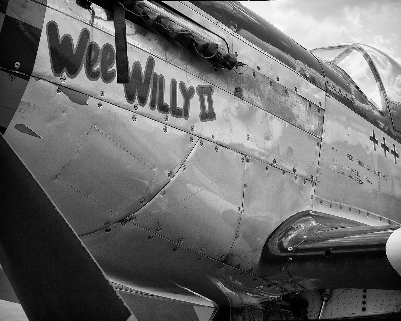 Black and white close-up of a WWII-era P-51 Mustang airplane named 