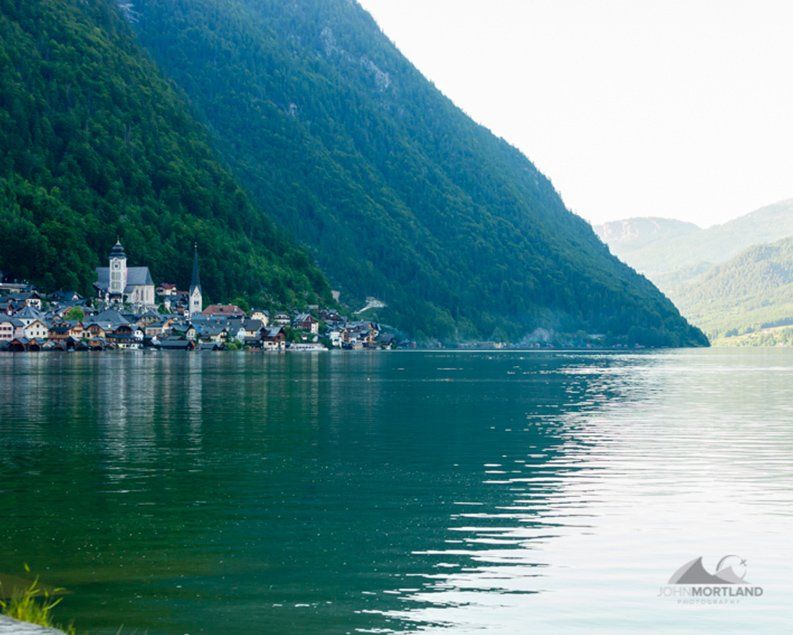 Hallstatt village nestled on a lake, beneath lush green mountains.