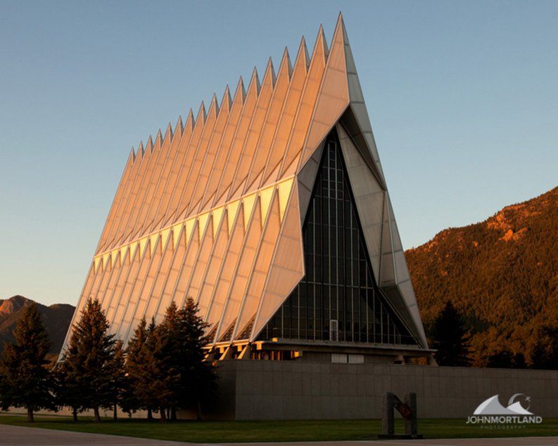 Air Force Academy Chapel with a triangular roof and spires at sunset.