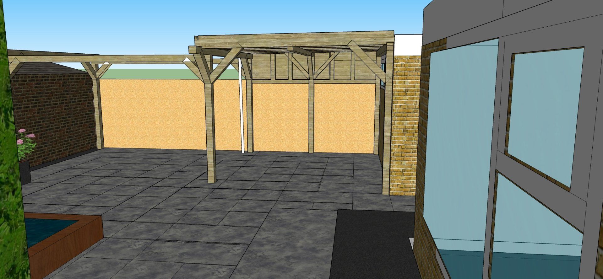 Buitenruimte met een houten pergola, een beige muur en een stenen vloer. Rechts bevindt zich een gebouw met ramen.
