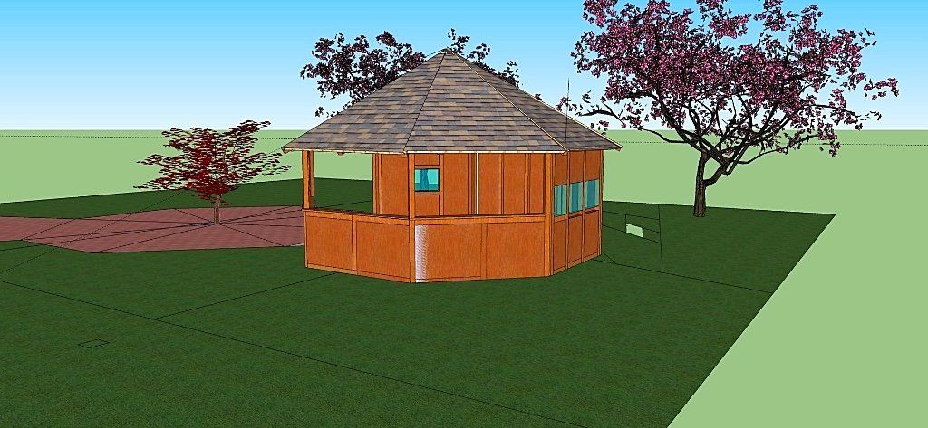 Een kleine, ronde houten hut met een rieten dak in een grasveld met bomen en een pad.