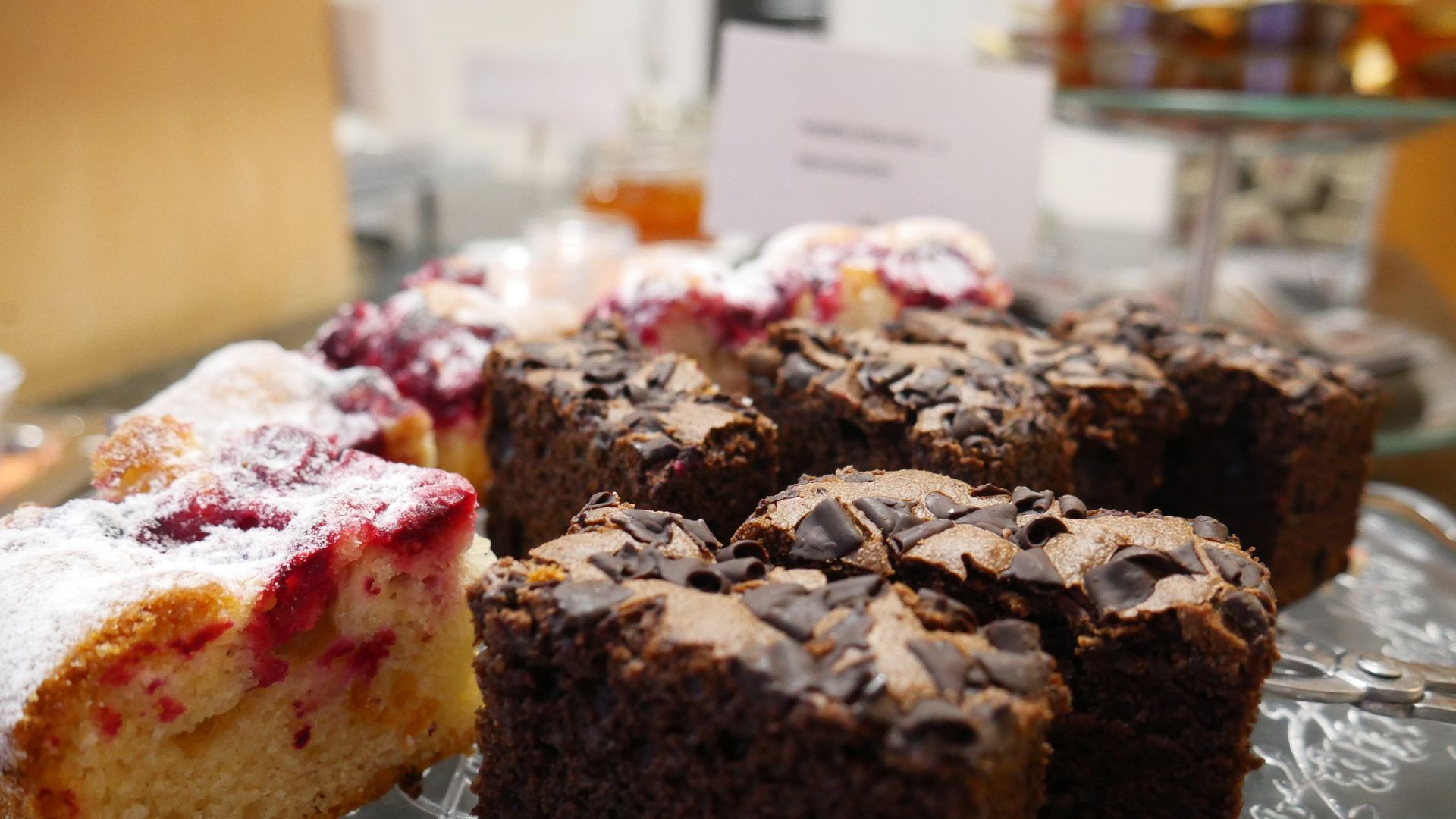 There are many different types of cakes on the table.