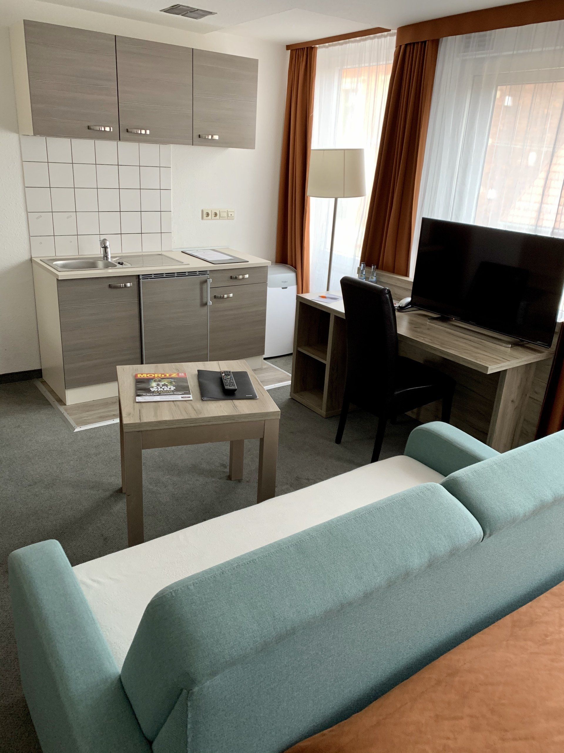 A living room with a couch and a flat screen tv