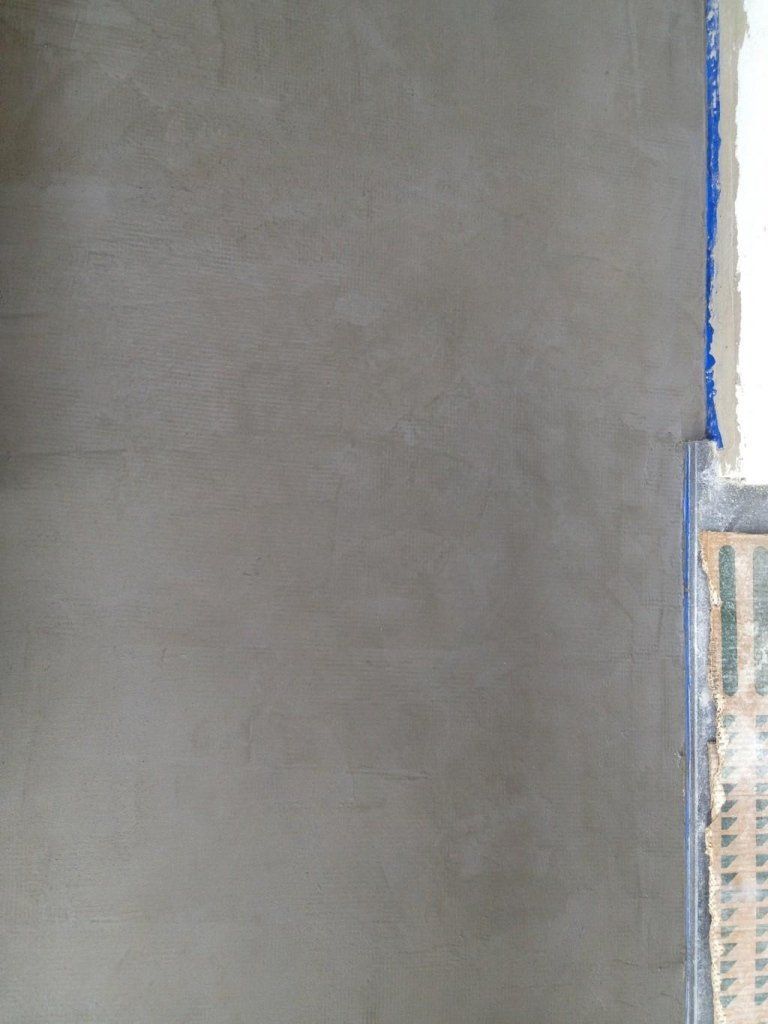 Un primo piano di un muro di cemento con del nastro blu.