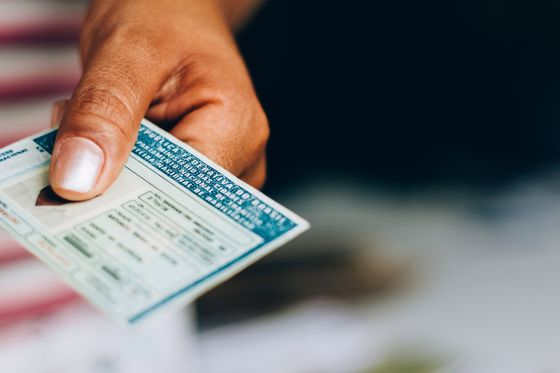 Man Holding a Card — Auburn, WA — Auburn License Agency, Inc. Man Holding a Card — Auburn, WA — Auburn License Agency, Inc.