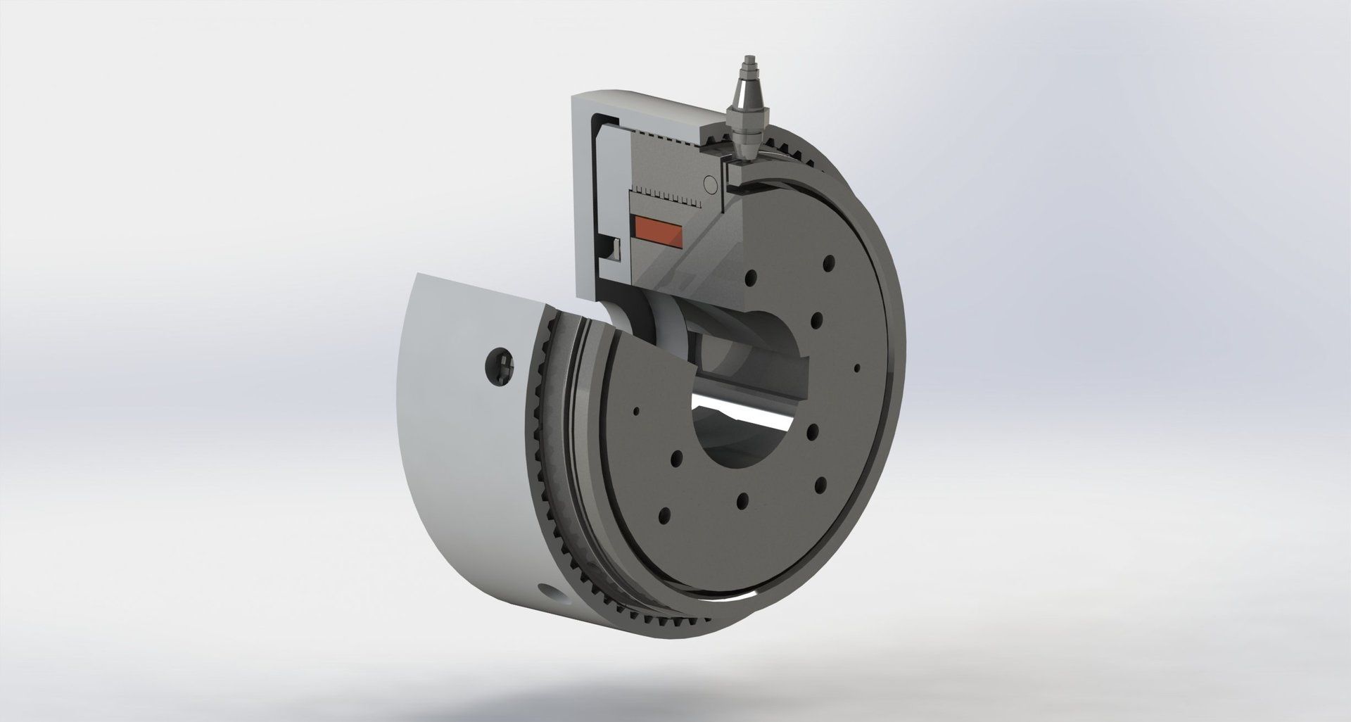Schnittansicht einer grauen Industriemaschine mit kreisförmigem Design, die die internen Komponenten sichtbar macht.