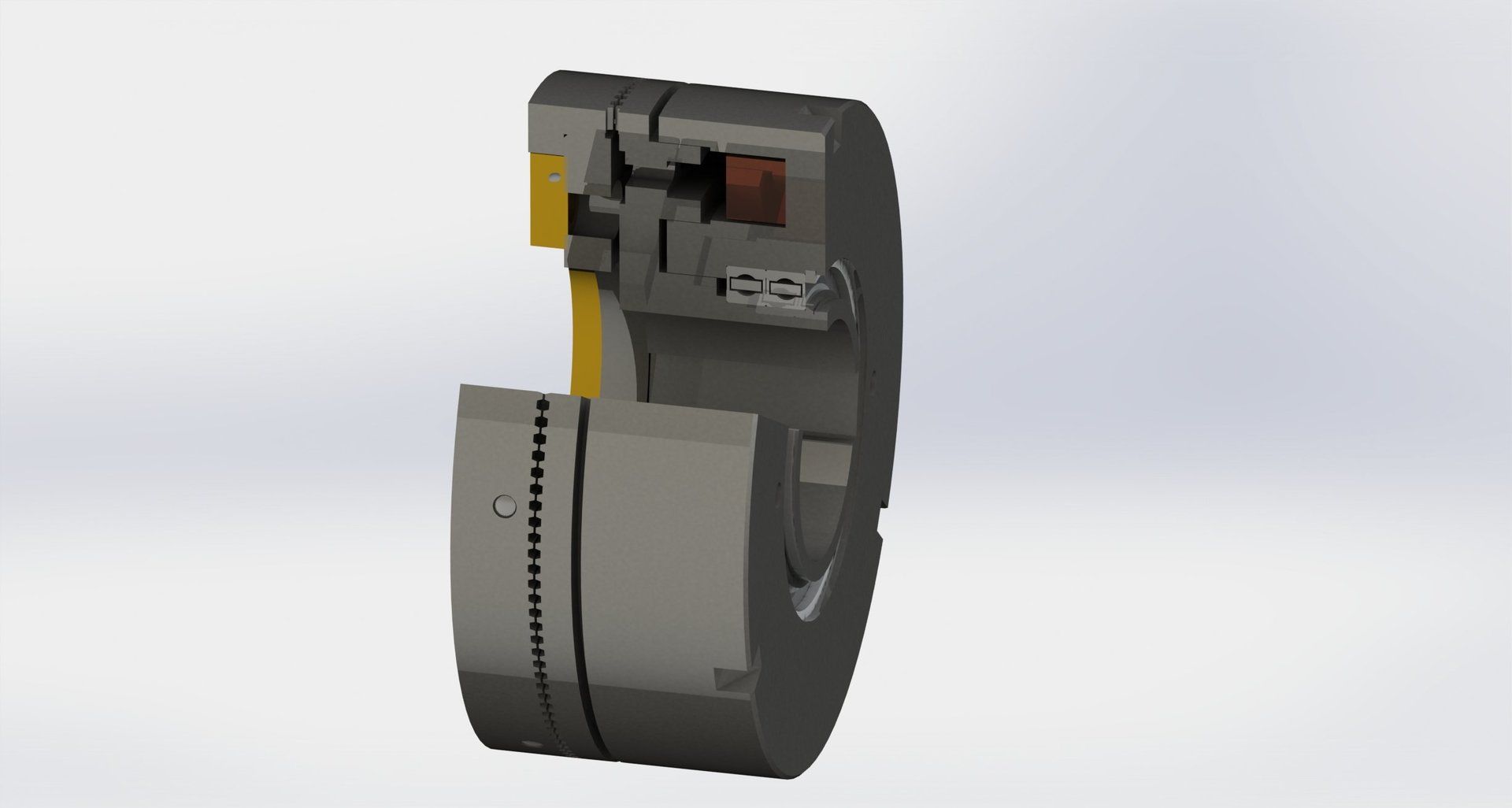 Querschnitt einer grauen mechanischen Vorrichtung mit gelben und braunen inneren Bauteilen.