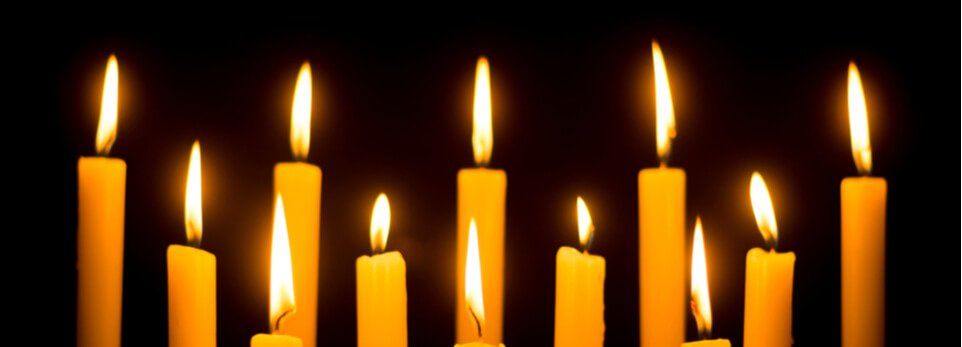 Candele accese che brillano su uno sfondo nero