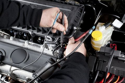 a mechanic testing the car engine