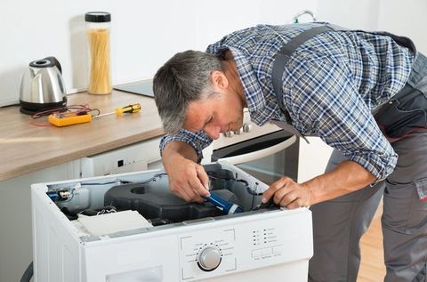 Repair man fixing a fridge repair man fixing a fridge