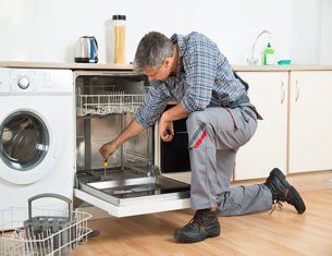 Repair man fixing a dishwasher repair man fixing a dishwasher