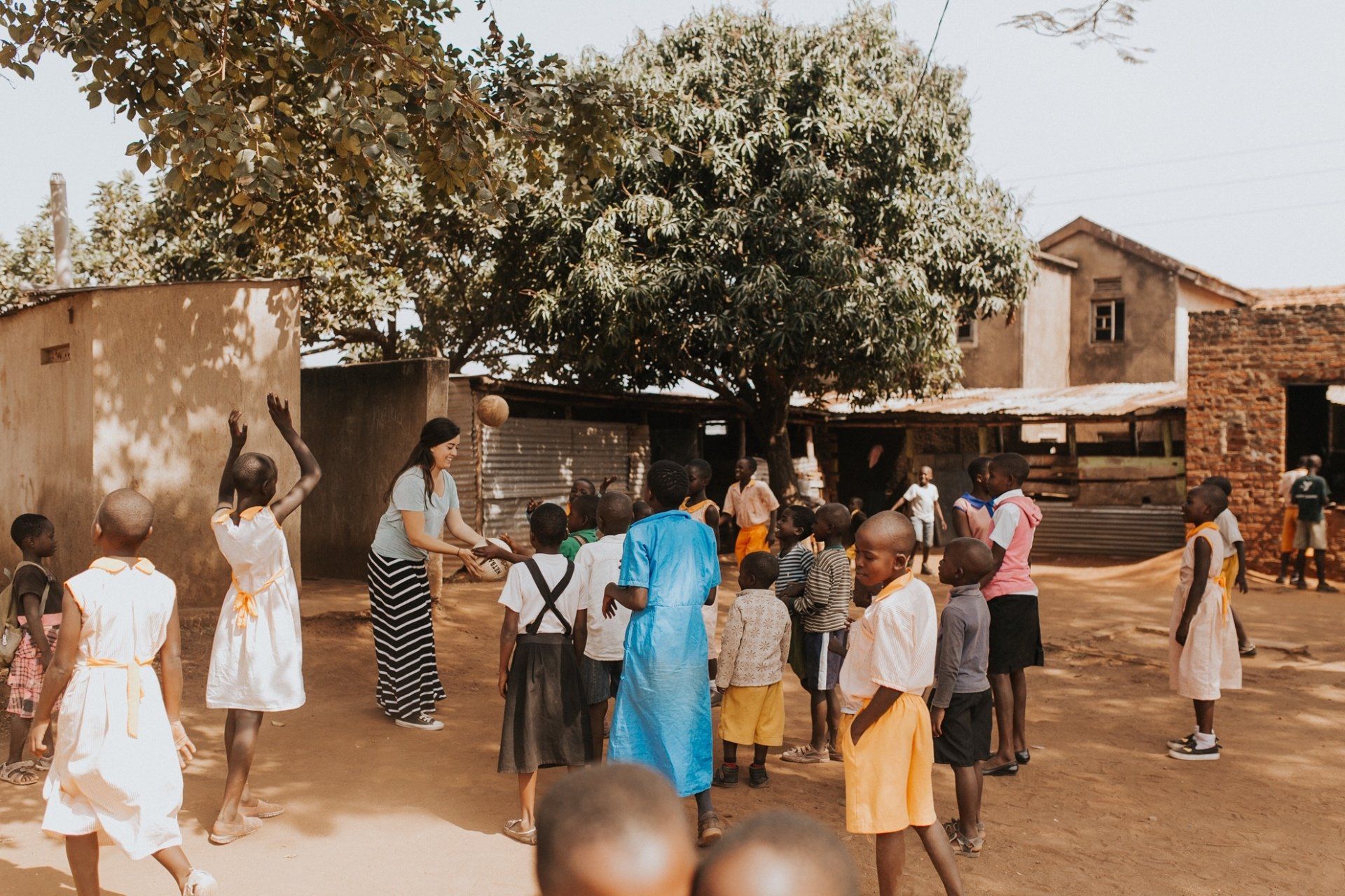 A group of children are playing with a ball outside