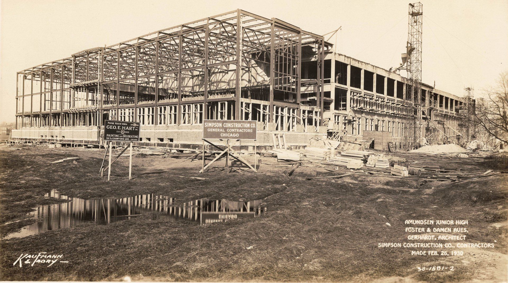 A black and white photo of a building under construction