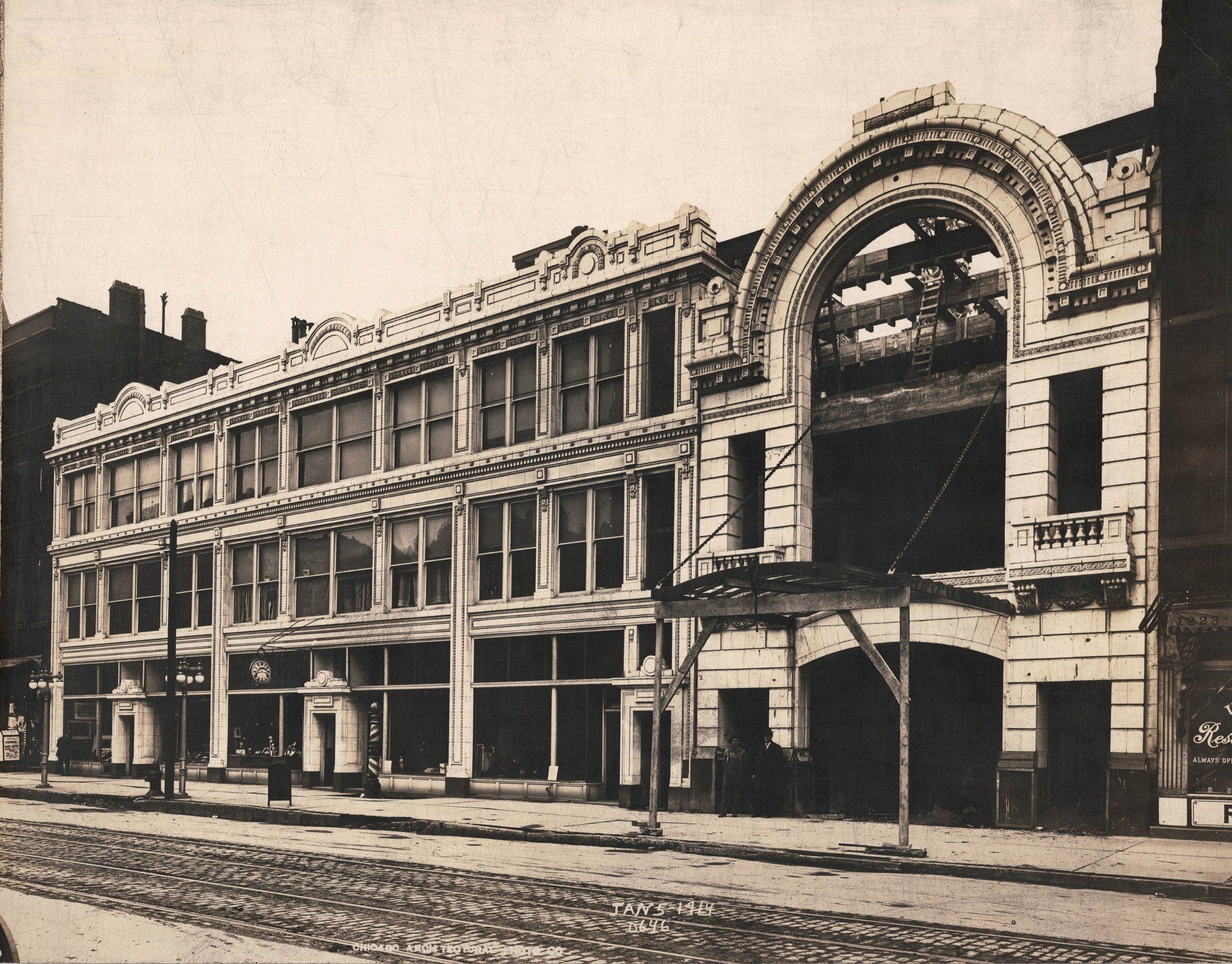 A black and white photo of a building with a balcony