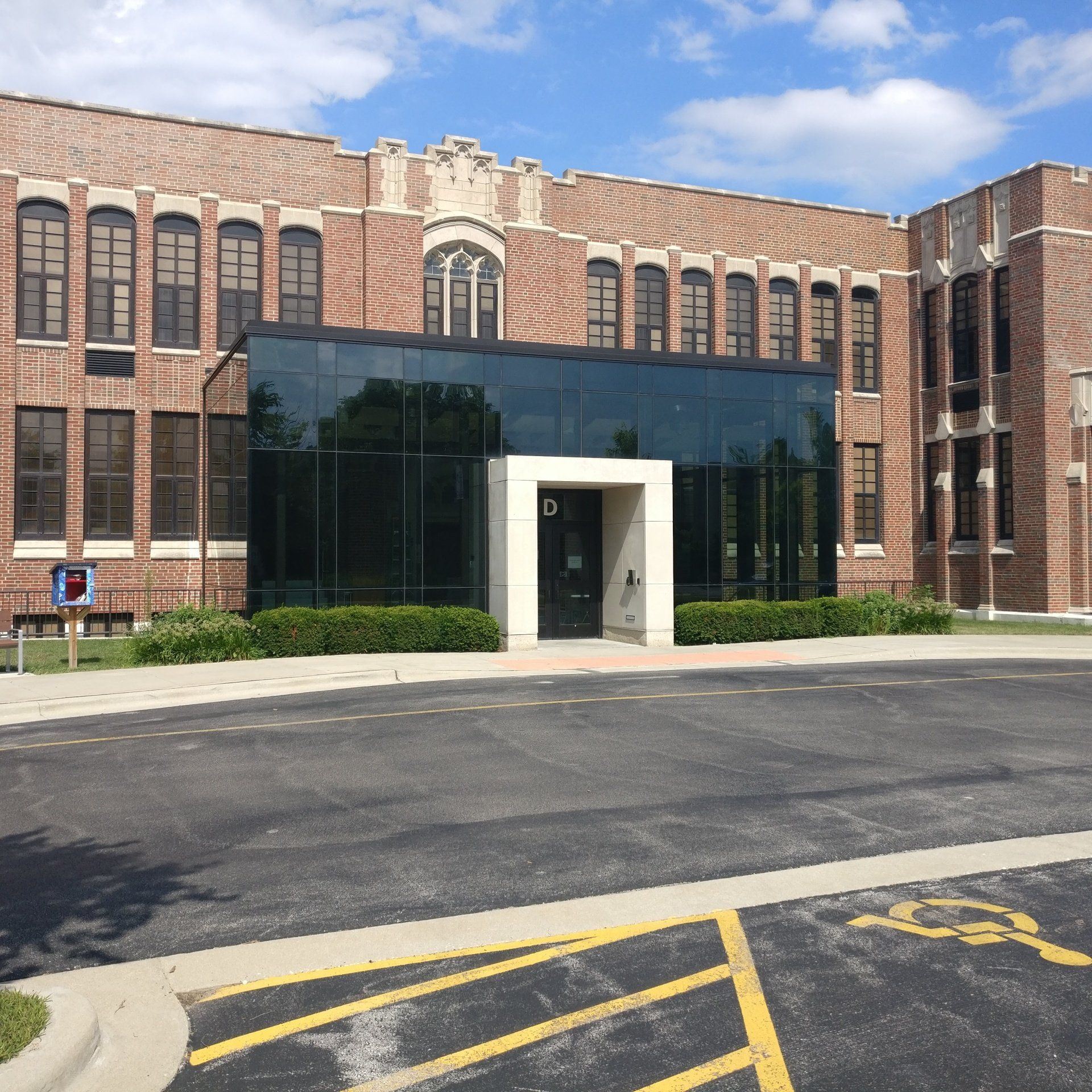 A large brick building with a handicapped parking spot in front of it