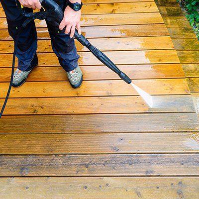 Deck Construction — Man Cleaning Deck Using Power Washing in Woodridge, IL