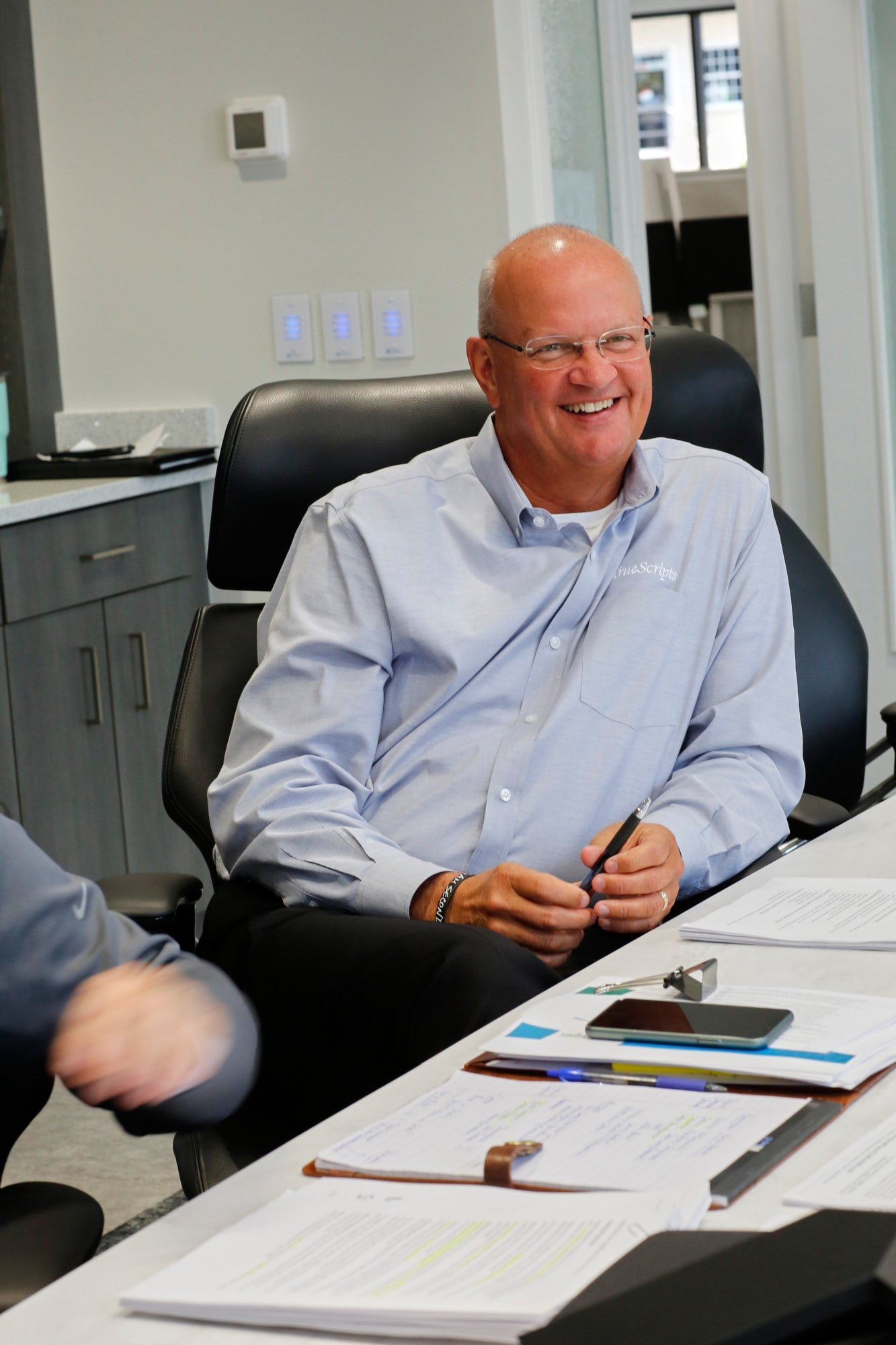 Dean Merder, TrueScripts President smiling at his desk