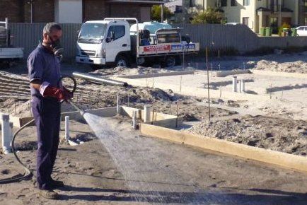 Spraying chemicals A technician performing termite treatment on a property in Perth