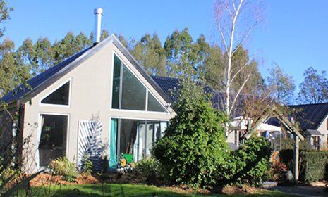 Constructed house with trees and grass Constructed house with trees and grass