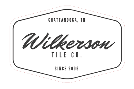 Logo for Wilkerson Tile Co. in Chattanooga, TN, with text inside a white outlined hexagon shape.