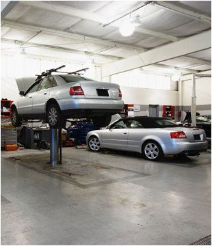 For MOTs in Rotherhithe call A.J Motors Two silver cars in a garage
