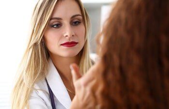 Cosmetic Fillers — Dermatologist Checking the Face of her Patient in Slidell, LA Cosmetic Fillers — Dermatologist Checking the Face of her Patient in Slidell, LA