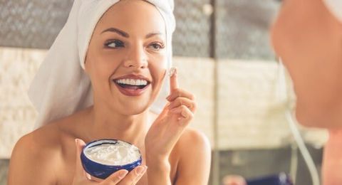 Acne Treatments — Woman Applying a Skin Product on her Face in Slidell, LA
