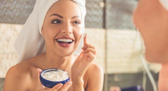 Acne Treatments — Woman Applying a Skin Product on her Face in Slidell, LA
