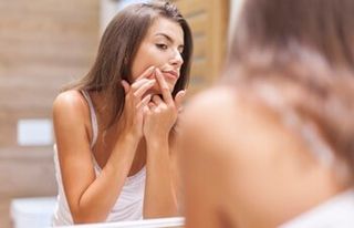 Acne — Woman Looking at her Acne in Slidell, LA