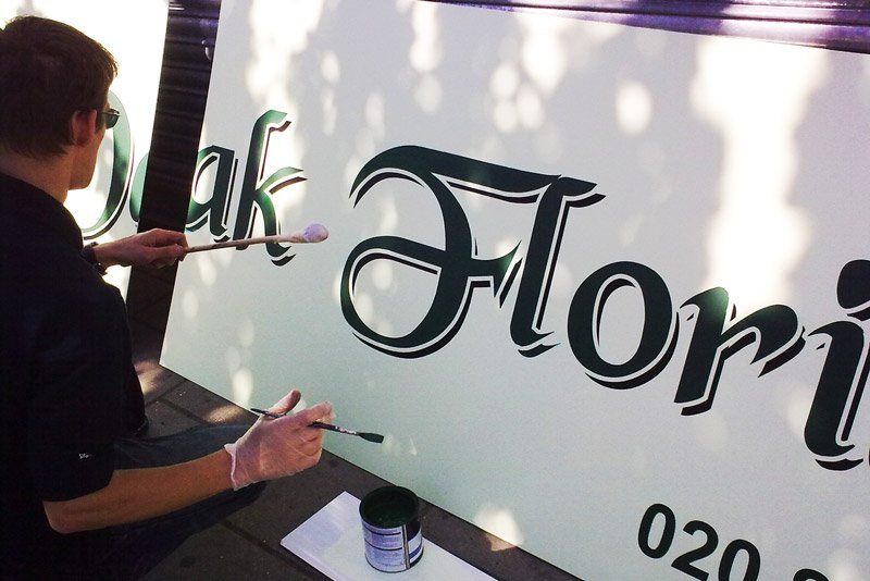 Hand painted sign outside a shop