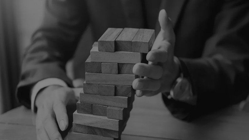 Wooden block tower representing strategy and risk management