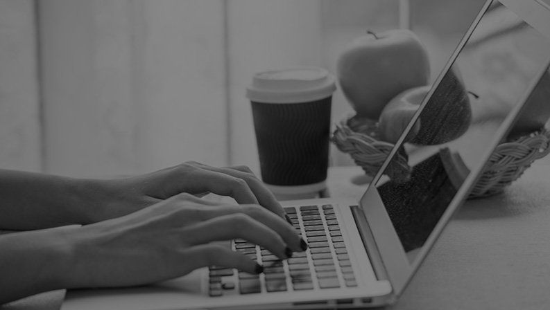 Person working on a laptop, representing digital marketing, content creation, and online business services.
