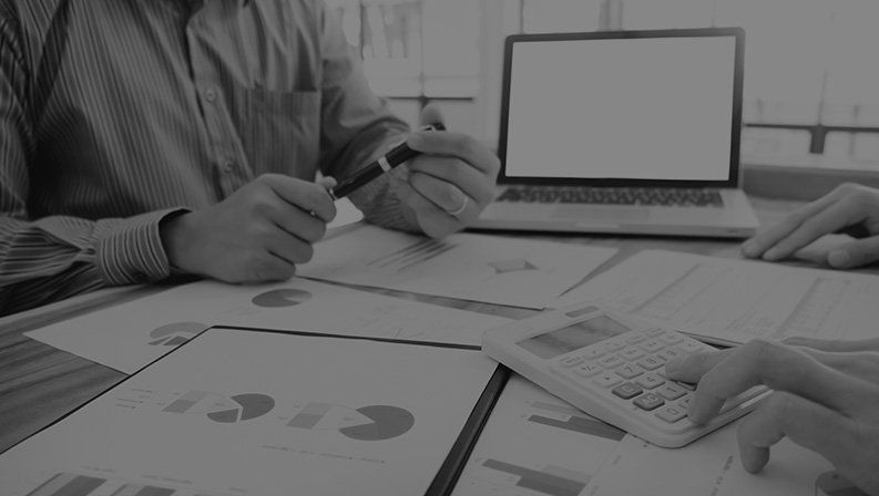 Business professionals reviewing design plans for custom website and digital design services.
