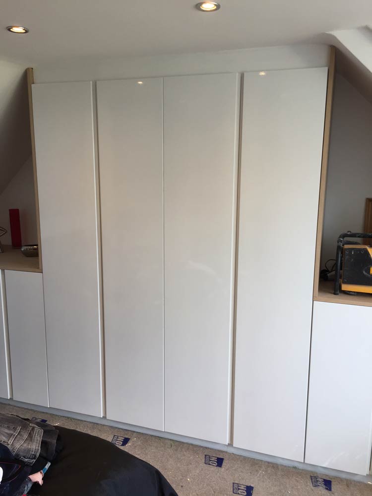 wooden partitions under staircase with white boards
