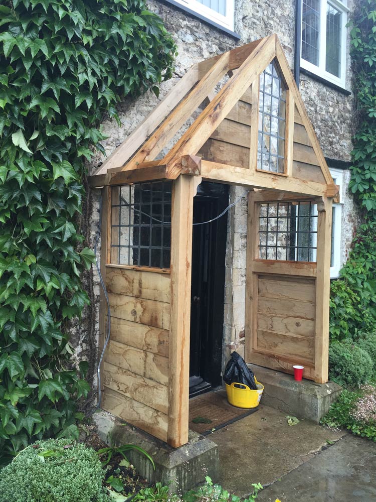 wooden porch with wooden doors opened