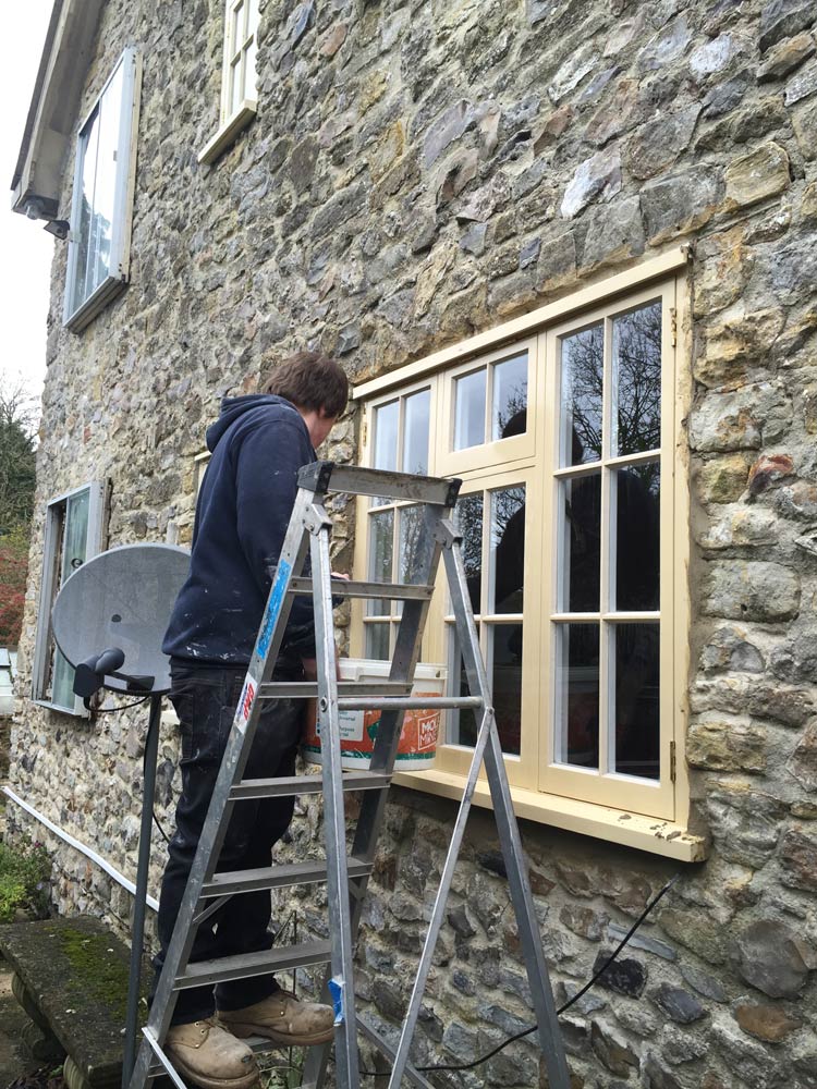 a specialist installing new wooden windows for home