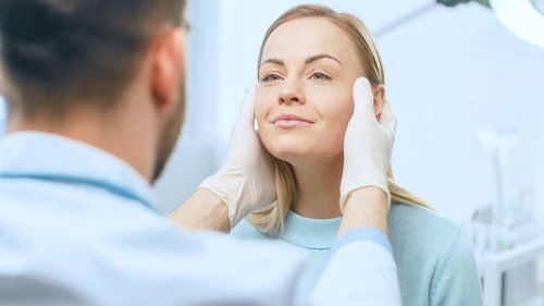 Botox - Cosmetic Surgeon Examines Beautiful Woman's Face in Joliet, IL Botox - Cosmetic Surgeon Examines Beautiful Woman's Face in Joliet, IL