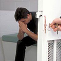 Jail — Person Being Locked Up in a Jail in Savannah, GA Jail — Person Being Locked Up in a Jail in Savannah, GA