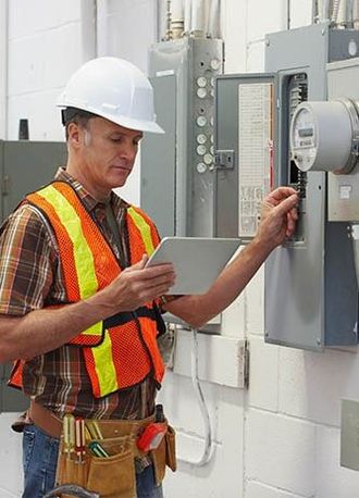 Electrician Checking Electric Cabinet — Electrician in Sebastian, FL Electrician Checking Electric Cabinet — Electrician in Sebastian, FL