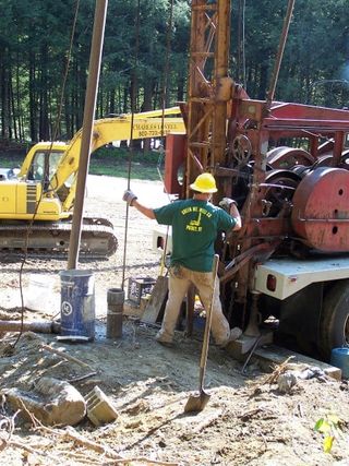 Water Well Flow — Man Installing Water Well in Putney, VT Water Well Flow — Man Installing Water Well in Putney, VT