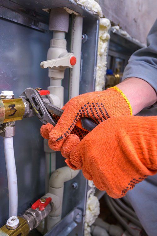 a plumber is working on a pipe with a wrench