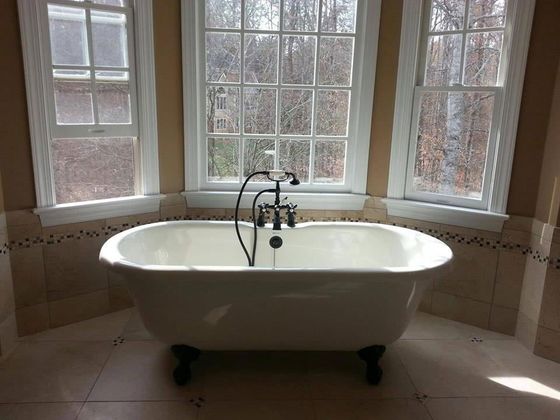 a bathtub in a bathroom next to a window