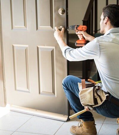 Man Installing Door — Door and Frame in Sacramento, CA Man Installing Door — Door and Frame in Sacramento, CA
