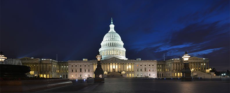 The capitol building in washington d.c. is lit up at night.