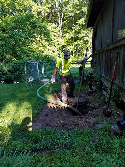 Septic Contractor — Worker Cleaning Septic Tank in Wrightstown, NJ Septic Contractor — Worker Cleaning Septic Tank in Wrightstown, NJ