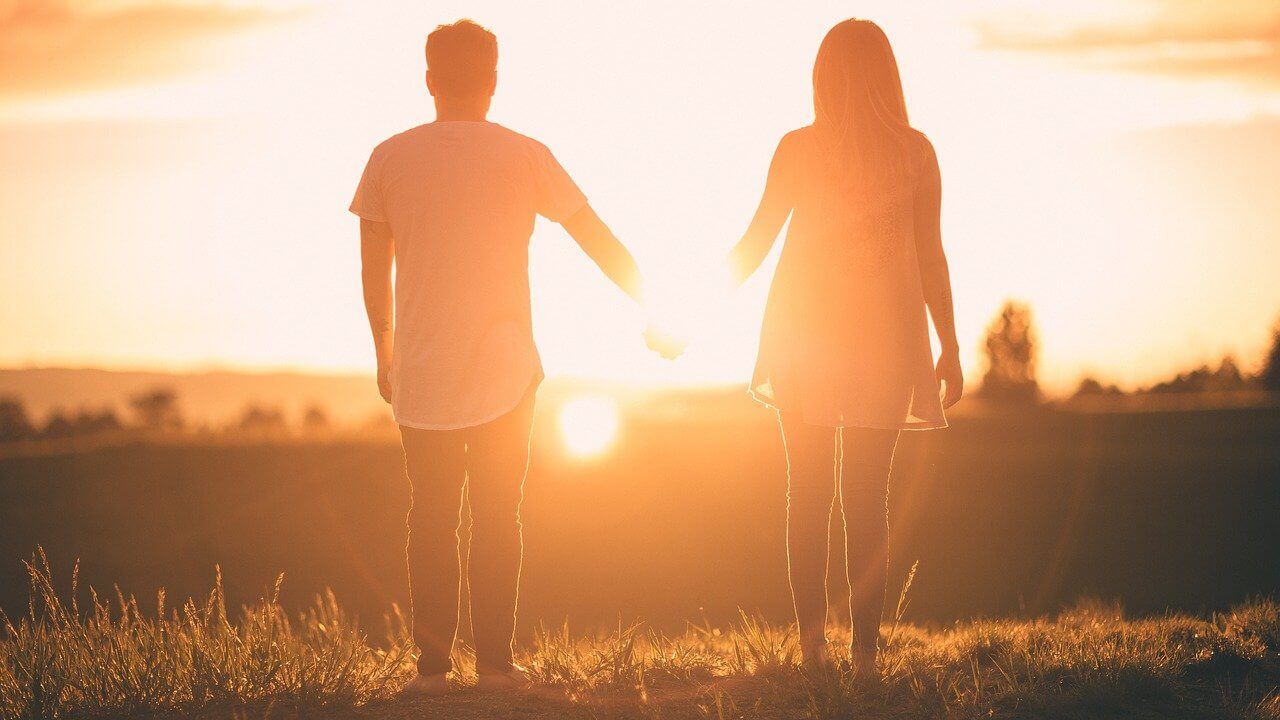 Difference Between Burial & Cremation Couple Walking Sunset