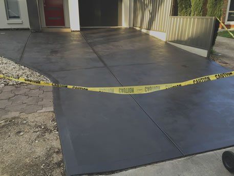 CONCRETE SEALING: Concrete driveway sealing in action.