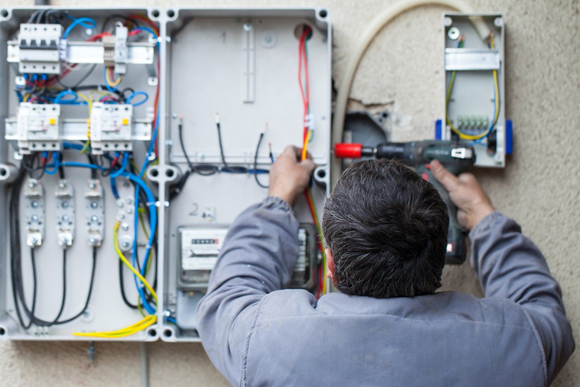 An Electrical Engineer Repairing Breakers — Ogden, UT — Johnson Electric Motor Inc An Electrical Engineer Repairing Breakers — Ogden, UT — Johnson Electric Motor Inc